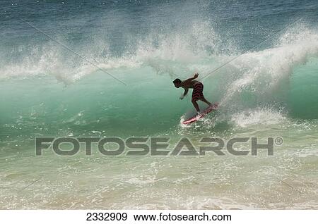 Surfer On The South Shore; Oahu, Hawaii, United States Of America View Large Photo Image Stock Photo - Surfer On The South Shore; Oahu, Hawaii, United States Of America. Fotosearch