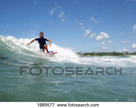 Stock Photo - Surfer On Wave, Low Angle View. Fotosearch