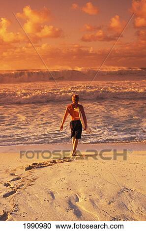 Surfer Walking Into The Water From The Beach View Large Photo Image Stock Image - Surfer Walking Into The Water From The Beach. Fotosearch