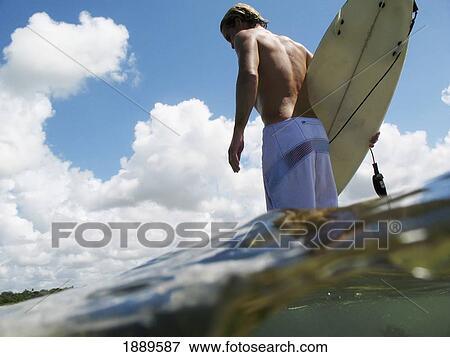 Surfer Walking Out Over A Reef, Split Level View Large Photo Image Stock Photo - Surfer Walking Out Over A Reef, Split Level. Fotosearch