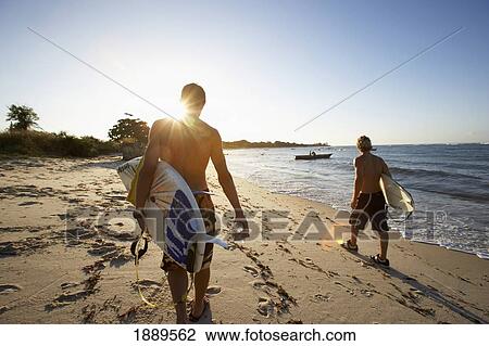 Surfers Carrying Surfboards On Beach View Large Photo Image Stock Image - Surfers Carrying Surfboards On Beach. Fotosearch