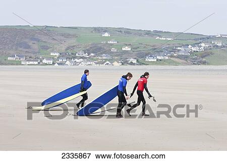 Stock Photo - Surfers On Newgale Beach; Pembrokeshire Coast Path, Wales, United Kingdom. Fotosearch
