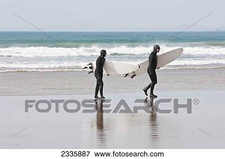 Surfers On Newgale Beach; Pembrokeshire Coast Path, Wales, United Kingdom View Large Photo Image Stock Photo - Surfers On Newgale Beach; Pembrokeshire Coast Path, Wales, United Kingdom. Fotosearch