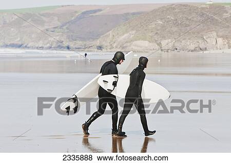 Stock Photo - Surfers On Newgale Beach; Pembrokeshire Coast Path, Wales, United Kingdom. Fotosearch