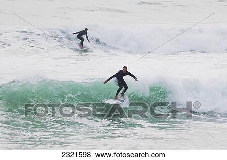 Surfers riding waves; Tarifa, Costa de la Luz, Cadiz, Andalusia, Spain View Large Photo Image Stock Photo - Surfers riding waves; Tarifa, Costa de la Luz, Cadiz, Andalusia, Spain. Fotosearch