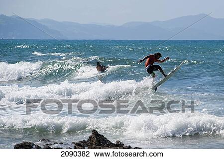 Stock Image - Surfing At Itzurun Beach, Zumaia, Basque Country, Spain. Fotosearch