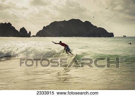 Stock Photography - Surfing In Praia Da Cachorro, Unesco World Heritage Site; Fernando De Noronha, Pernambuco, Brazil. Fotosearch