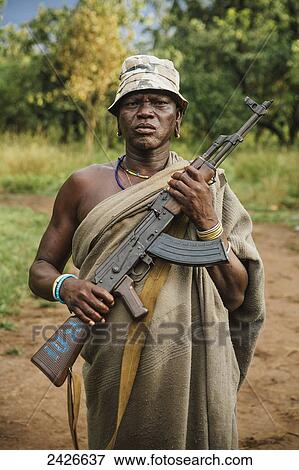 Suri man with AK47 assault rifle, Omo region, Southwest Ethiopia; Kibish, Ethiopia View Large Photo Image Stock Photo - Suri man with AK47 assault rifle, Omo region, Southwest Ethiopia; Kibish, Ethiopia. Fotosearch
