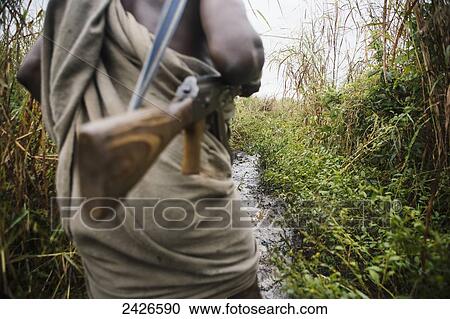 Stock Image - Suri man with AK47 assualt rifle, Omo region, Southwest Ethiopia; Kibish, Ethiopia. Fotosearch