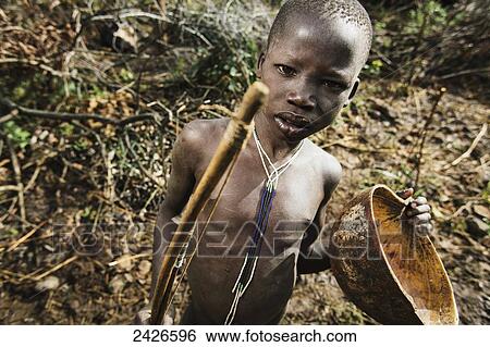 Suri (Surma) tribe cattle herder with bowl for collecting cattle blood, Omo region, Southwest Ethiopia; Kibish, Ethiopia View Large Photo Image Stock Photograph - Suri (Surma) tribe cattle herder with bowl for collecting cattle blood, Omo region, Southwest Ethiopia; Kibish, Ethiopia. Fotosearch