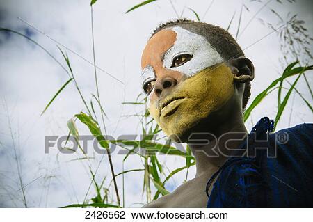 Surma child with face painted with pigment made from powdered coloured stones, Omo region, Southwest Ethiopia; Kibish, Ethiopia View Large Photo Image Stock Image - Surma child with face painted with pigment made from powdered coloured stones, Omo region, Southwest Ethiopia; Kibish, Ethiopia. Fotosearch