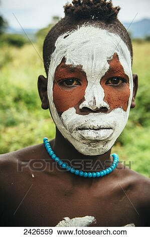 Surma child with face painted with pigment made from powdered coloured stones, Omo region, Southwest Ethiopia; Kibish, Ethiopia View Large Photo Image Stock Photo - Surma child with face painted with pigment made from powdered coloured stones, Omo region, Southwest Ethiopia; Kibish, Ethiopia. Fotosearch