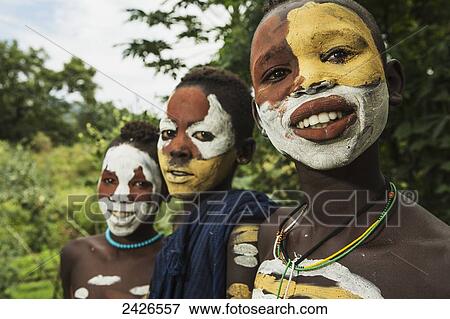 Surma children with faces painted with pigment made from powdered coloured stones, Omo region, Southwest Ethiopia; Kibish, Ethiopia View Large Photo Image Stock Photo - Surma children with faces painted with pigment made from powdered coloured stones, Omo region, Southwest Ethiopia; Kibish, Ethiopia. Fotosearch