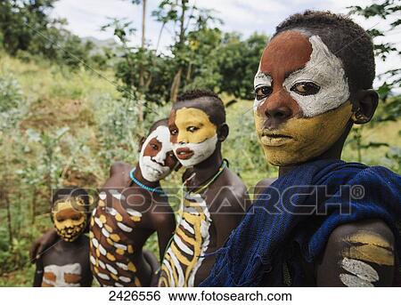 Surma children with faces painted with pigment made from powdered coloured stones, Omo region, Southwest Ethiopia; Kibish, Ethiopia View Large Photo Image Stock Photograph - Surma children with faces painted with pigment made from powdered coloured stones, Omo region, Southwest Ethiopia; Kibish, Ethiopia. Fotosearch