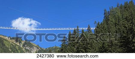 Stock Image - Suspension bridge and blue sky; Tirol, Austria. Fotosearch
