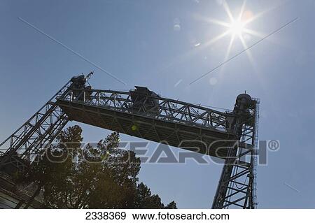 Stock Photo - Suspension Bridge, Raised With Sun Burst And Blue Sky; Port Colborne, Ontario, Canada. Fotosearch