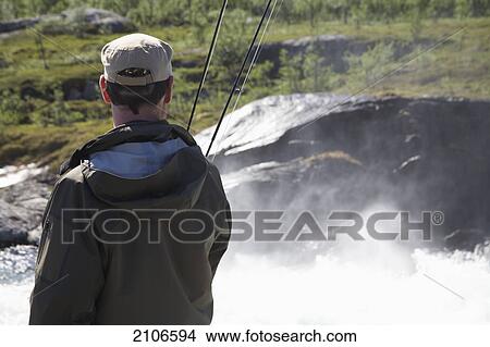Picture - Sweden, Man fly fishing; Miekak Lapland. Fotosearch