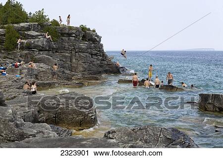 Swimmers and sunbathers on rocky beach of Georgian Bay in Bruce Peninsula National Park; Ontario, Canada View Large Photo Image Stock Image - Swimmers and sunbathers on rocky beach of Georgian Bay in Bruce Peninsula National Park; Ontario, Canada. Fotosearch