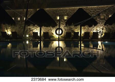Picture - Swimming pool at nighttime; Tulum, Mexico. Fotosearch