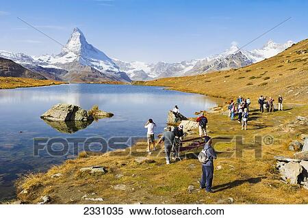 Stock Photography - Switzerland, Tourists by Stellisee lake and Matterhorn; Valais. Fotosearch
