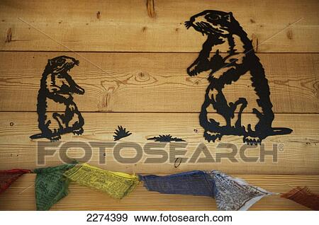 Stock Photo - Switzerland, Val d'Anniviers, with Tibetan prayer flags at a ski lodge on the way up to the Col de Sorebois; Zinal, Illustrations of marmots burned into wood. Fotosearch