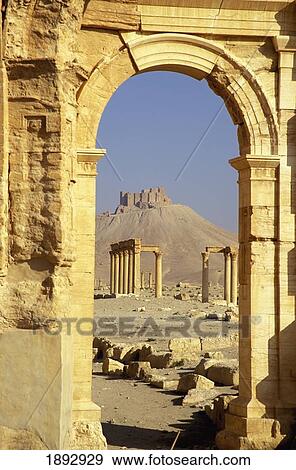 Stock Photo - Syria, Main Site; Palmyra, Castle And Colonnaded Street Through Arch. Fotosearch