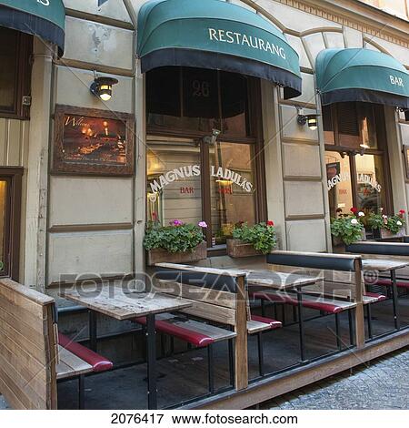 Stock Photo - Tables And Benches On An Outdoor Restaurant Patio; Stockholm Sweden. Fotosearch