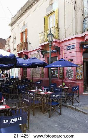 Stock Image - Tables Chairs And Umbrellas On An Outdoor Restaurant Patio; Buenos Aires Argentina. Fotosearch
