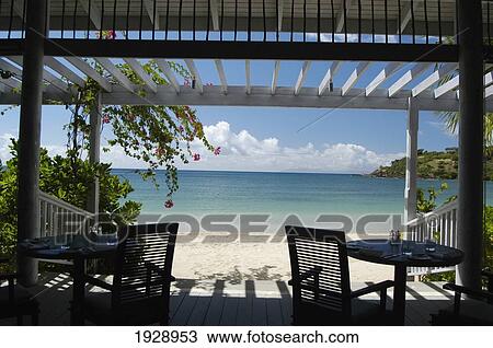 Stock Image - Tables On Patio Of Beach Hotel. Fotosearch