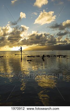 Stock Image - Tahiti, Teahupo'o, Silhouette Of A Woman On Stand Up Paddle Board. Fotosearch