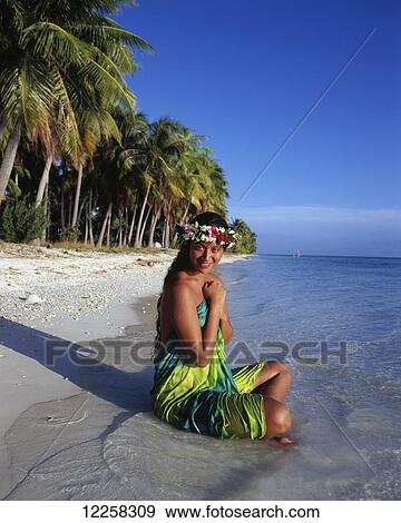 Stock Photo - Tahitian woman bathing by the waters edge; Tahiti. Fotosearch