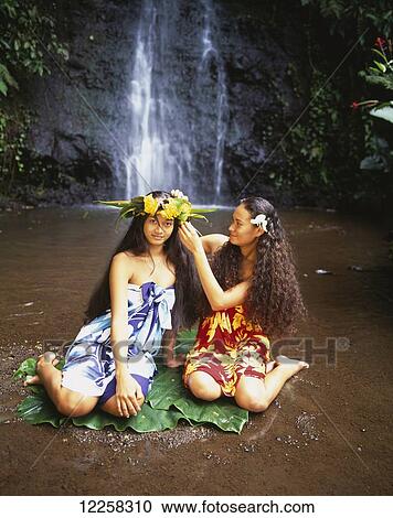Stock Image - Tahitian women bathing by a waterfall; Tahiti. Fotosearch