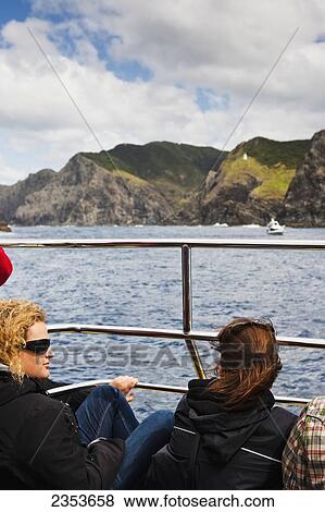 Taking A Boat Cruise Through The Bay To The Hole In The Rock, A Popular New Zealand Destination; Paihia, New Zealand View Large Photo Image Stock Photo - Taking A Boat Cruise Through The Bay To The Hole In The Rock, A Popular New Zealand Destination; Paihia, New Zealand. Fotosearch