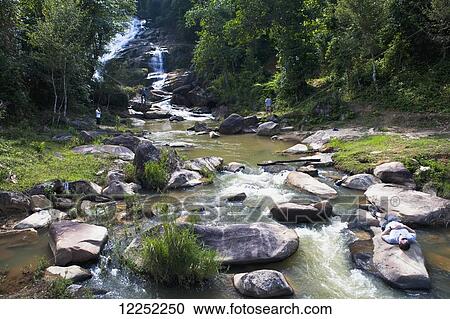 Taking a break at the Tat soloi waterfall in Northern Laos; Laos View Large Photo Image Stock Image - Taking a break at the Tat soloi waterfall in Northern Laos; Laos. Fotosearch