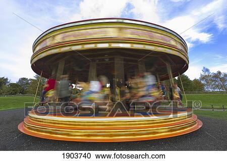 Stock Image - Taking A Ride On A Colorful Carousel; Beamish, Durham, England. Fotosearch