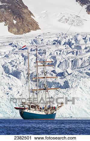Stock Image - Tall ship in the icy waters of the Fuglesongen glacier; Svalbard, Norway. Fotosearch