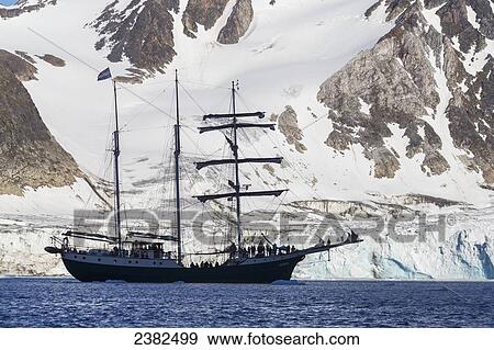 Tall ship in the icy waters of the Fuglesongen glacier; Svalbard, Norway View Large Photo Image Stock Photo - Tall ship in the icy waters of the Fuglesongen glacier; Svalbard, Norway. Fotosearch