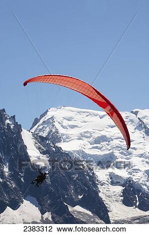 Tandem paraglider flight above Chamonix-Mont Blanc valley, with Mont Blanc mountain in background; France View Large Photo Image Stock Image - Tandem paraglider flight above Chamonix-Mont Blanc valley, with Mont Blanc mountain in background; France. Fotosearch