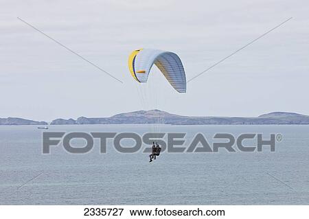 Tandem Paragliding Above Newgale Beach Along Pembrokeshire Coast Path Near St David's; Wales, Uk View Large Photo Image Stock Photo - Tandem Paragliding Above Newgale Beach Along Pembrokeshire Coast Path Near St David's; Wales, Uk. Fotosearch