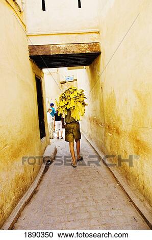 Stock Image - Tanned Hide Carrier On Street. Fotosearch