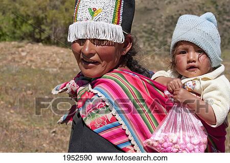 Tarabuco woman carrying girl, Jatun Yampara Indigenous Community, Chuquisaca Department, Bolivia View Large Photo Image Stock Image - Tarabuco woman carrying girl, Jatun Yampara Indigenous Community, Chuquisaca Department, Bolivia. Fotosearch