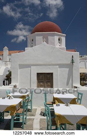 Taverna tables set outside a church; Mykonos Town, Mykonos, Cyclades, Greek Islands, Greece View Large Photo Image Stock Photo - Taverna tables set outside a church; Mykonos Town, Mykonos, Cyclades, Greek Islands, Greece. Fotosearch