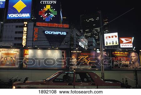 Taxi By Illuminated Commercial Signs In Shinjuku View Large Photo Image Stock Photo - Taxi By Illuminated Commercial Signs In Shinjuku. Fotosearch