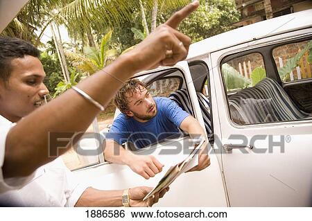 Taxi Driver Pointing Out Directions To Backpacker In Car View Large Photo Image Stock Photograph - Taxi Driver Pointing Out Directions To Backpacker In Car. Fotosearch