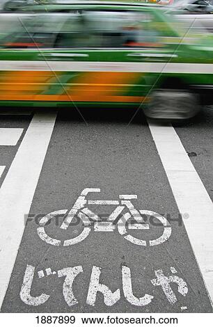 Stock Photo - Taxi Driving Over Bicycle Path, Blurred Motion. Fotosearch