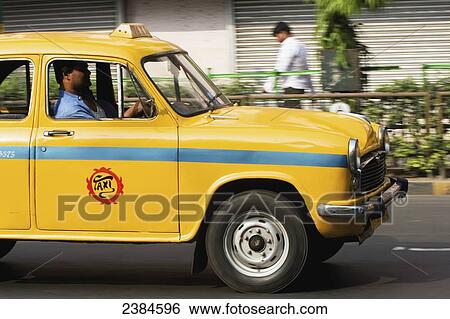 Stock Photograph - Taxi on a road; Calcutta, West Bengal State, India. Fotosearch