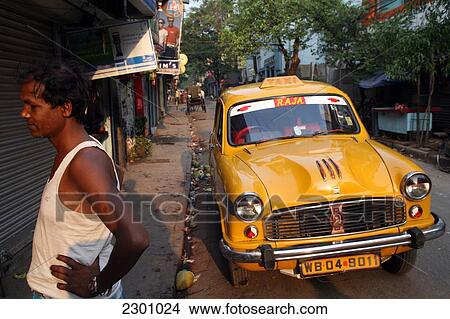 Picture - Taxi parked up on Sudder Street, the budget conscious area of Calcutta Taxi driver waits for a fare from a backpacker/tourist. Calcutta / Kolkata, the capital of West Bengal State, India, Asia.. Fotosearch