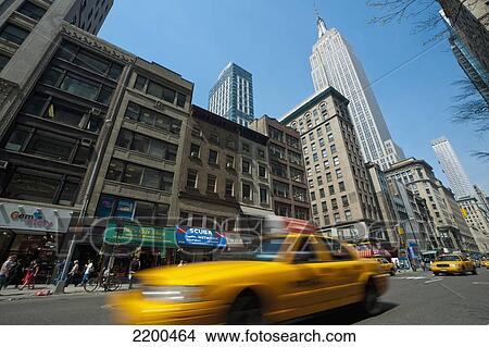 Taxi Passing In Front Of The Empire State Building, Manhattan, New York, Usa View Large Photo Image Picture - Taxi Passing In Front Of The Empire State Building, Manhattan, New York, Usa. Fotosearch
