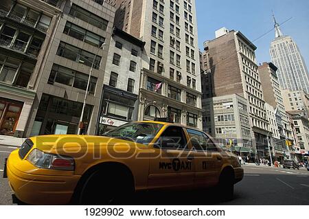 Taxi Passing In Front Of The Empire State Building, Manhattan, New York, Usa View Large Photo Image Stock Image - Taxi Passing In Front Of The Empire State Building, Manhattan, New York, Usa. Fotosearch