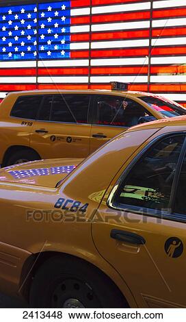 Taxis and the American flag, Manhattan; New York City, New York, United States of America View Large Photo Image Stock Photo - Taxis and the American flag, Manhattan; New York City, New York, United States of America. Fotosearch